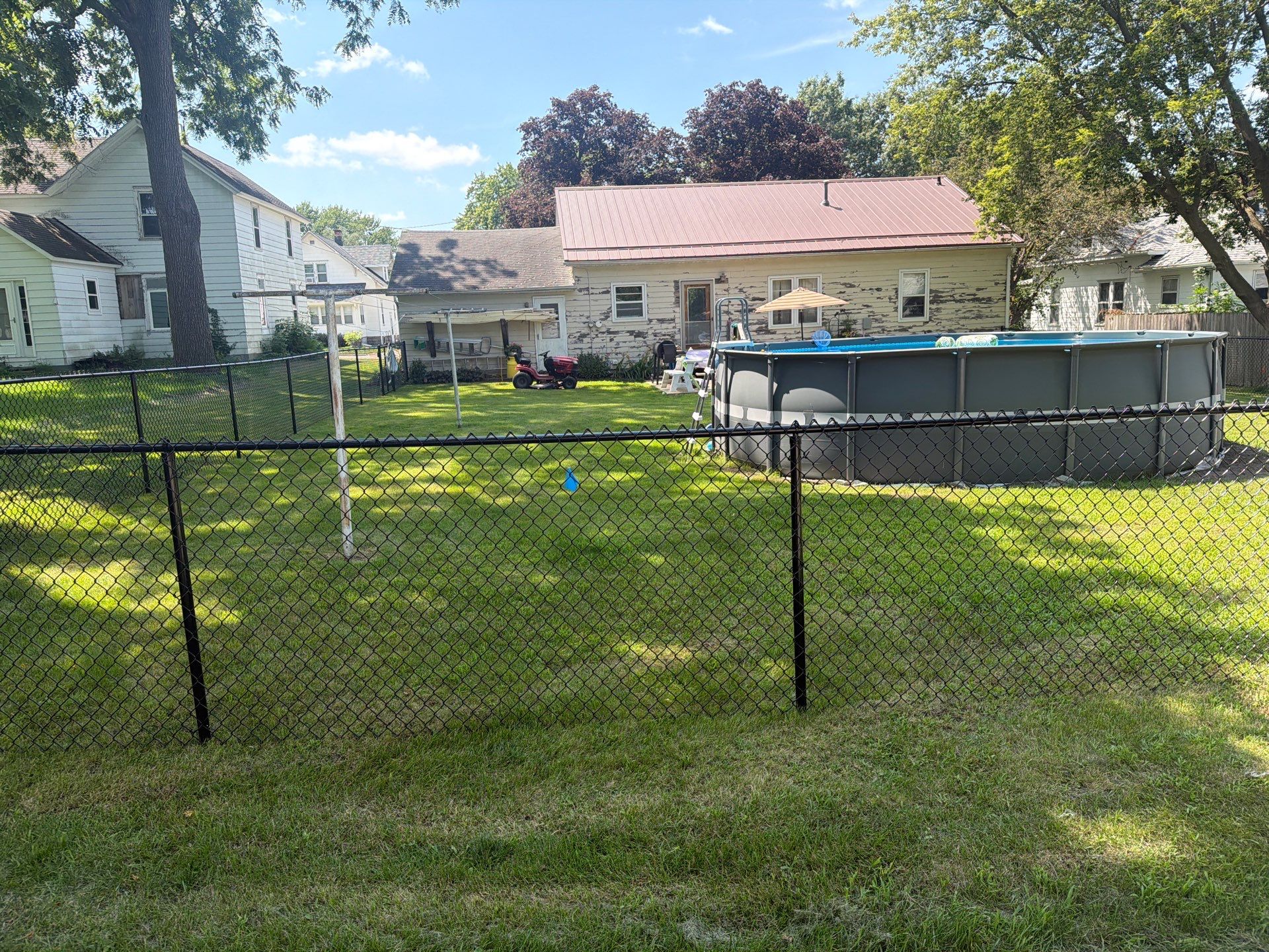 Black Chain Link Backyard Fence Installation in Tripoli, IA by Perfect Picket Fence and Stain