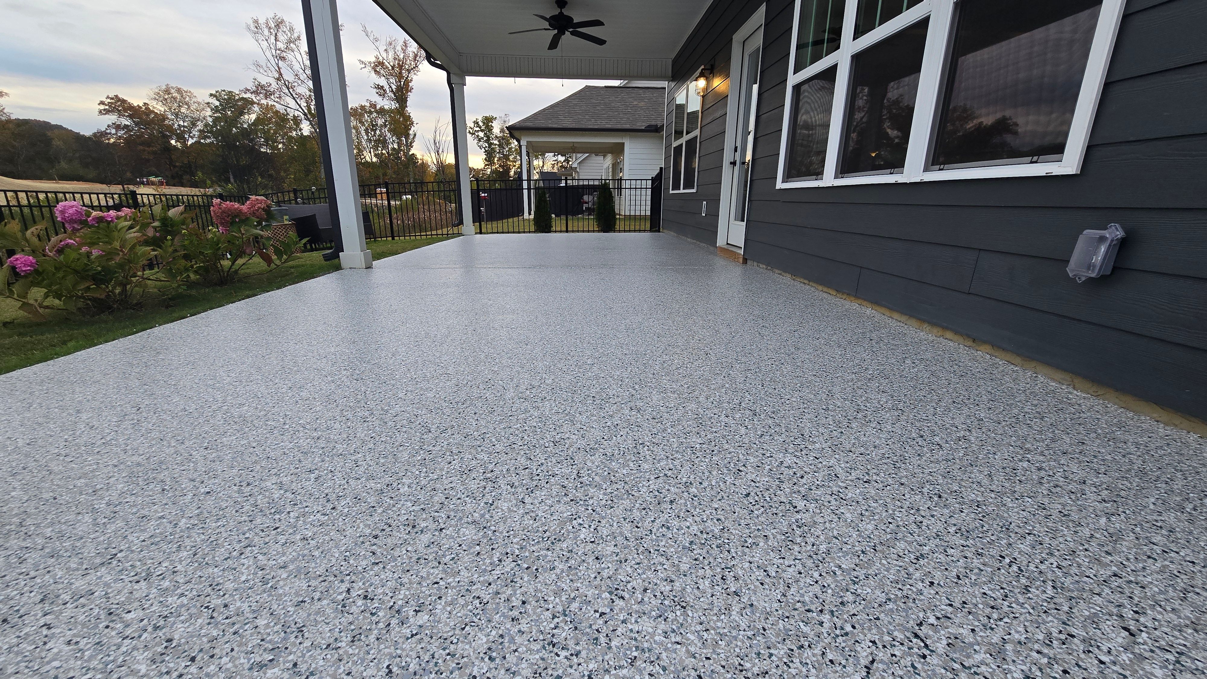 Sidewalk, Porch, and Back Patio Using Creekbed and Nordic Green by Elite Floor Solutions