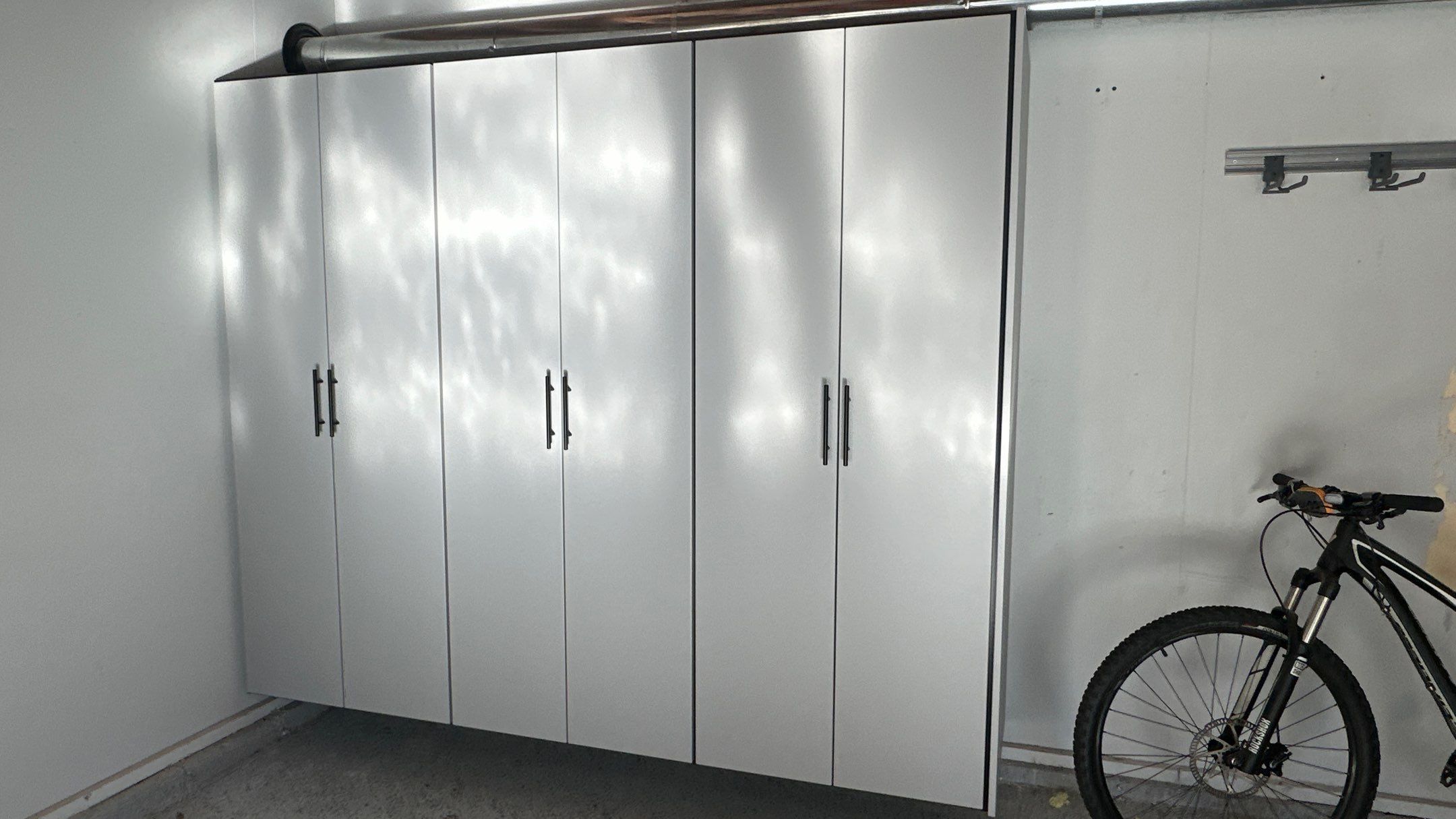 Jamie N added these beautiful cabinets for extra storage space by Banner Garage