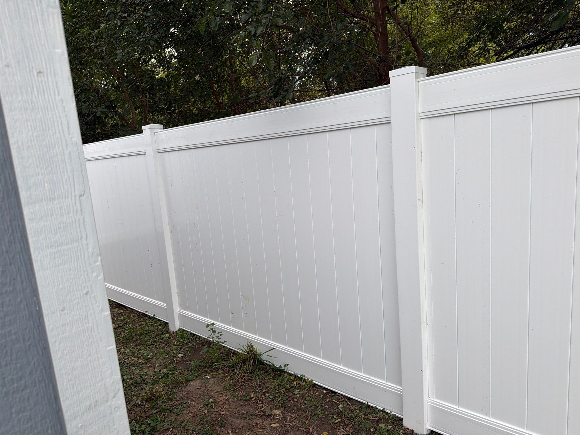 White Vinyl Privacy Fence Installation in Raymond, IA by Perfect Picket Fence and Stain