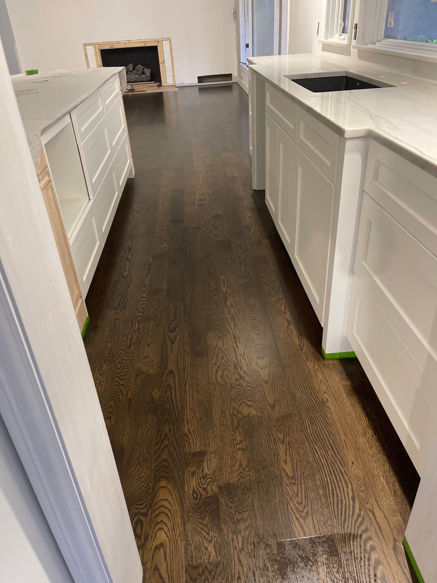 New Flooring installation using 4" White oak select grade plain sawn Ebony Stain by Ann Arbor Hardwoods