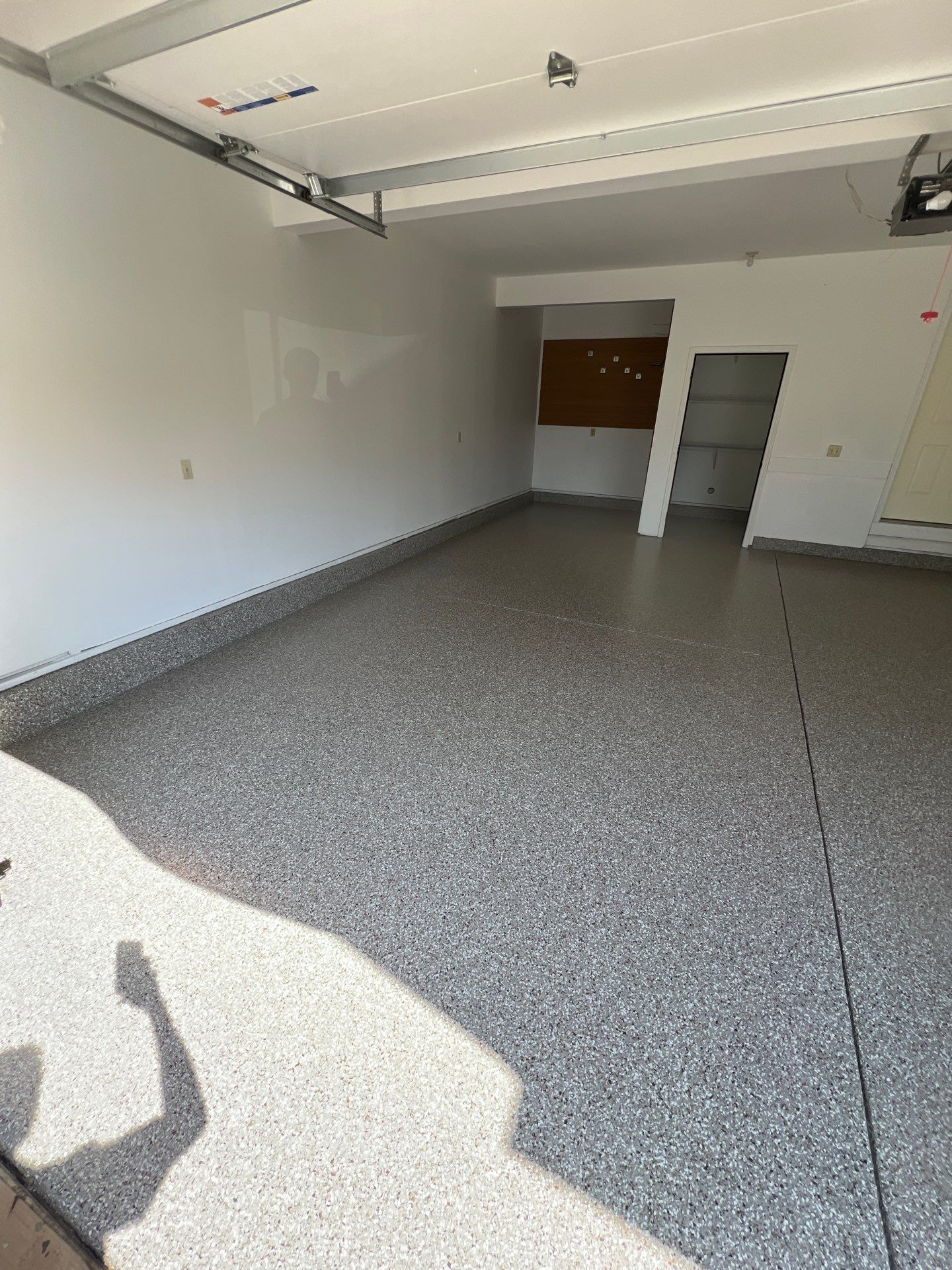 Garage floor in Holt using Smoke Flake by Freedom Concrete Coatings. 