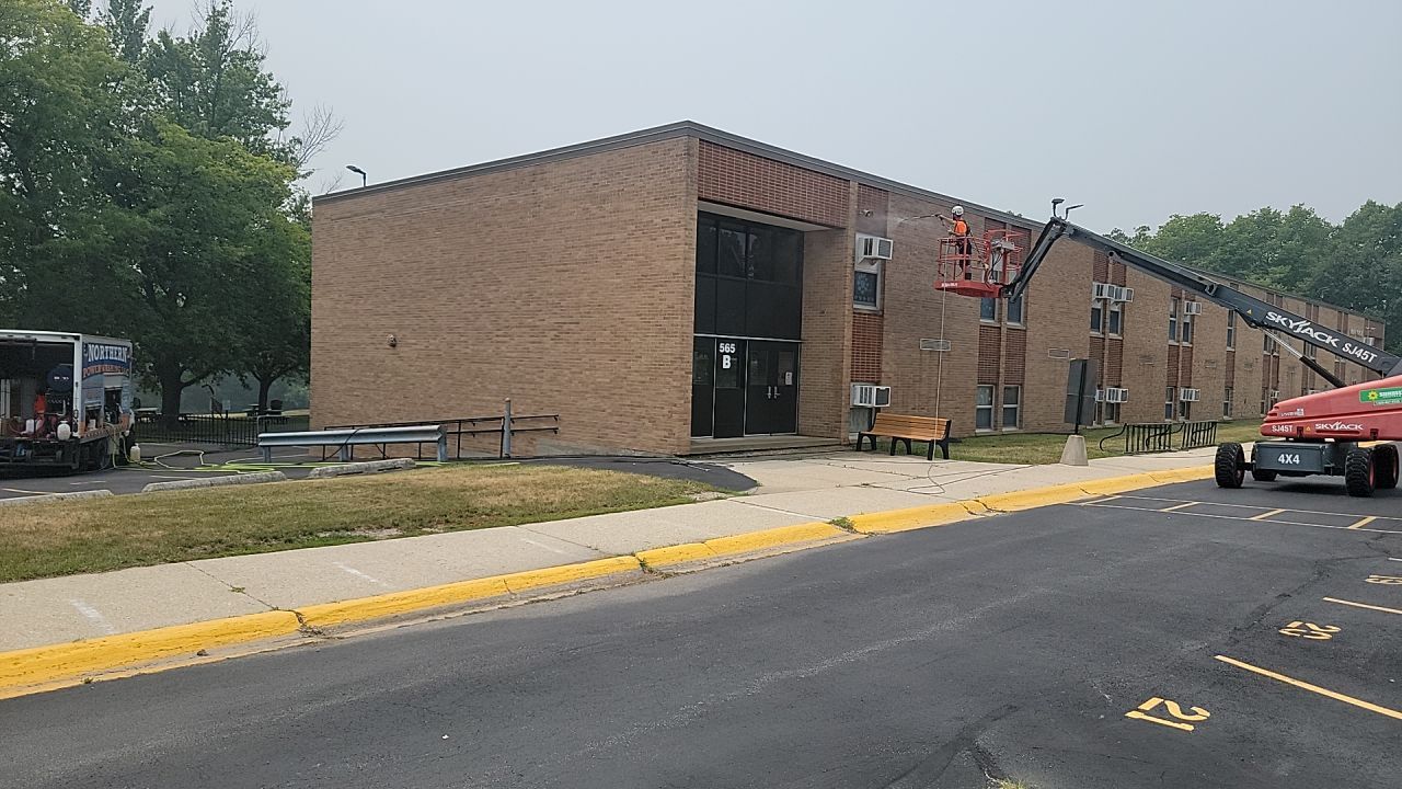 Commercial brick exterior cleaning by Northern Power Washing LLC.