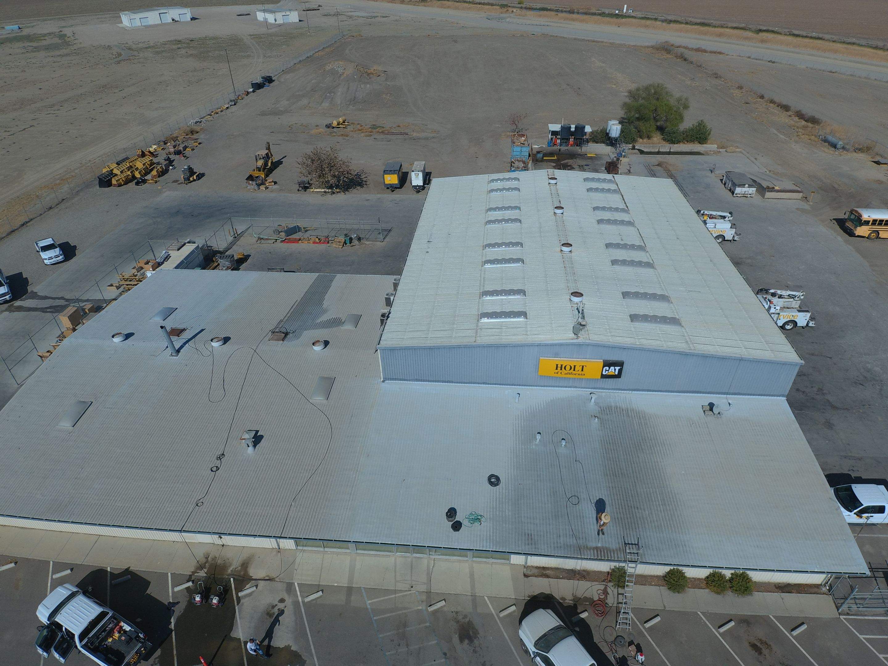 Metal roof restoration on commercial roof using Conklin Benchmark/ PUMA XL acrylic coatings over metal and foam by Straight Edge Roofing Inc