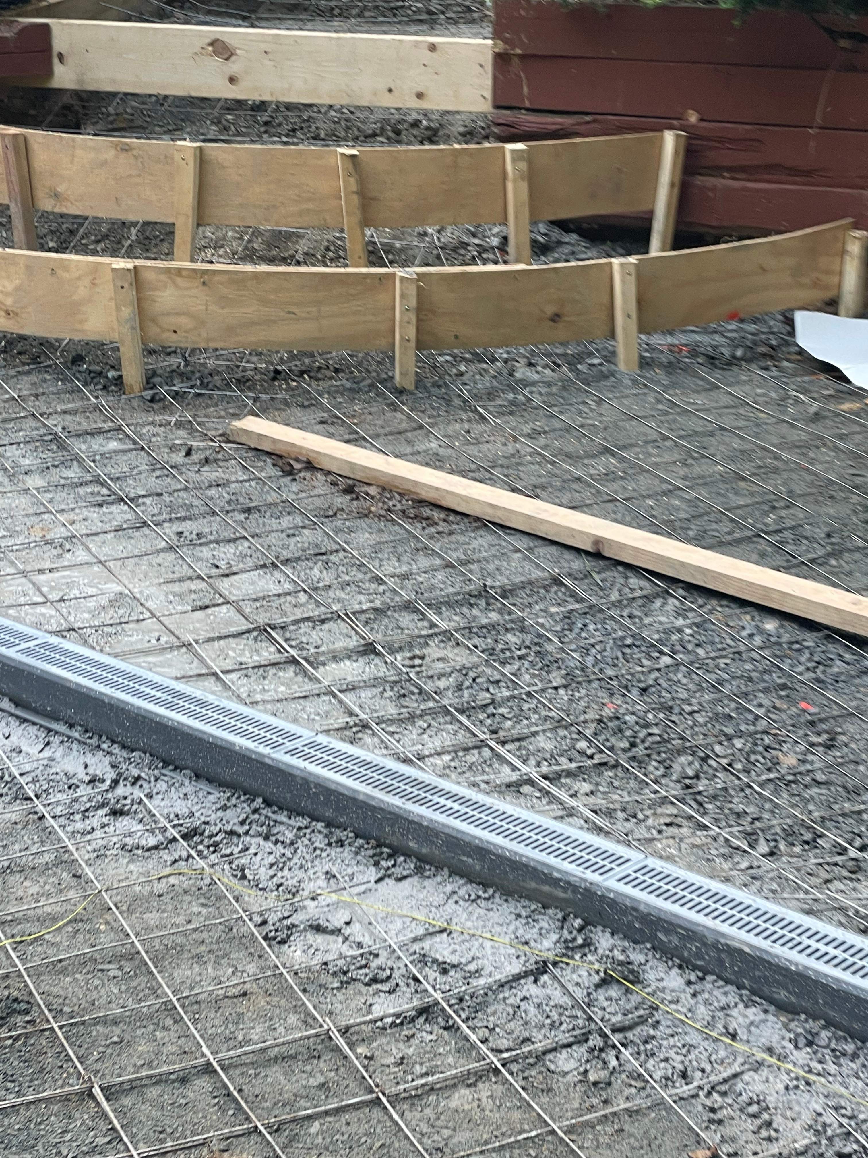 Pool Surround remodel with retaining walls, new waterfall and water slide by Fairfax Contractors, LLC