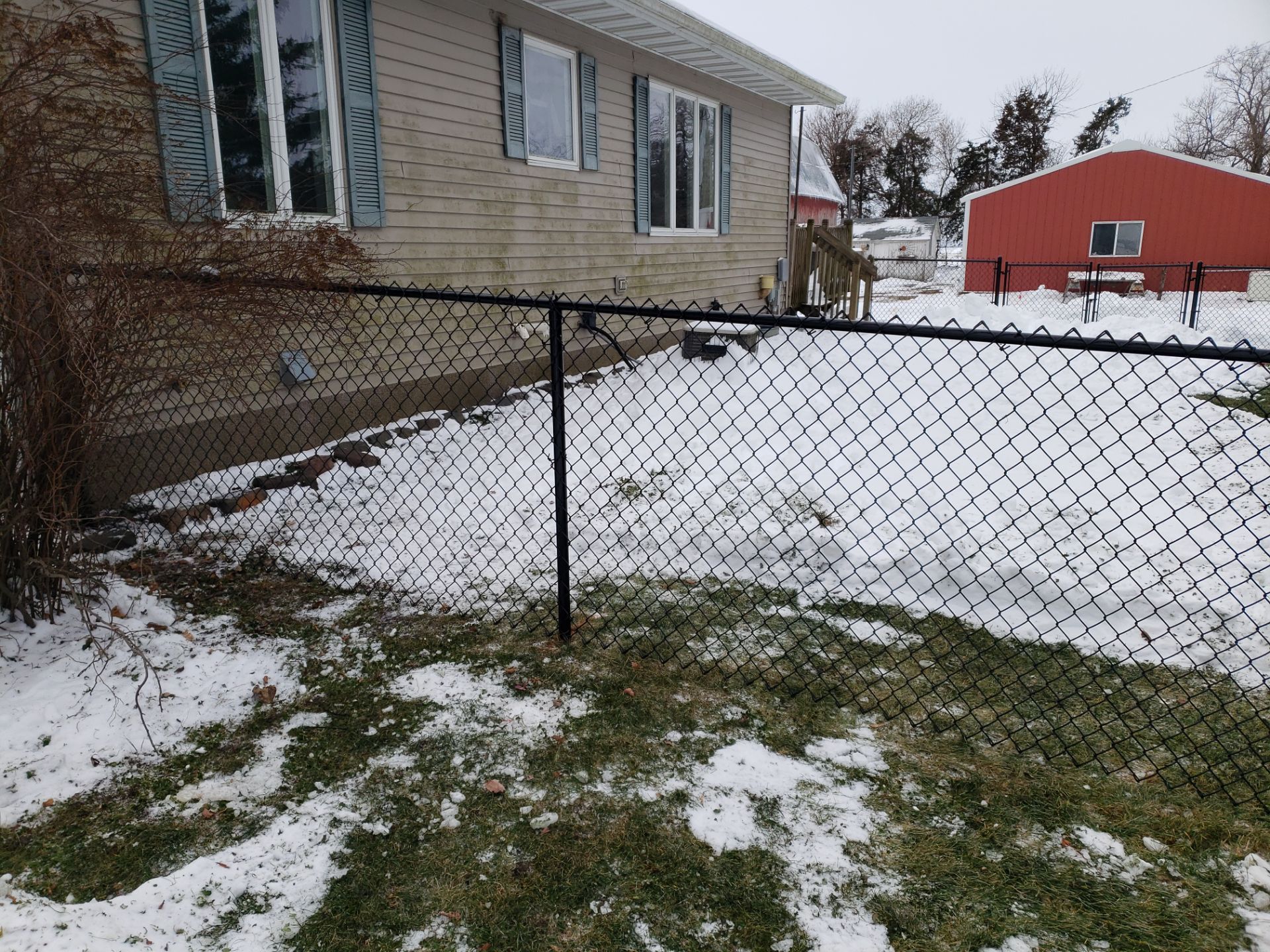 Black Vinyl-Coated Chain Link Fence Installation in Oelwein by Perfect Picket Fence and Stain