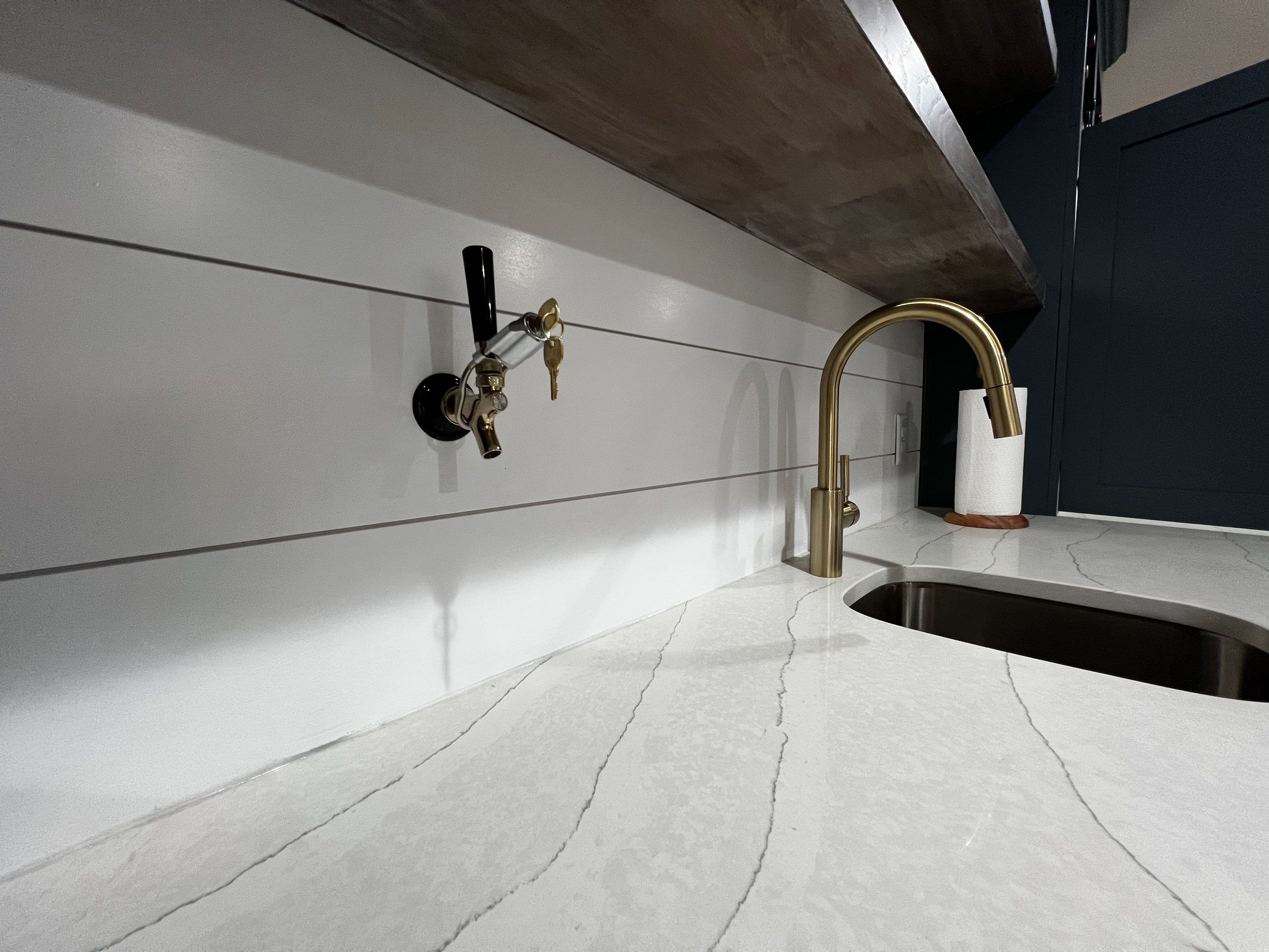 Modern Basement Remodeling in Woodstock with Custom Live-Edge Bar by Swift Home Renovations