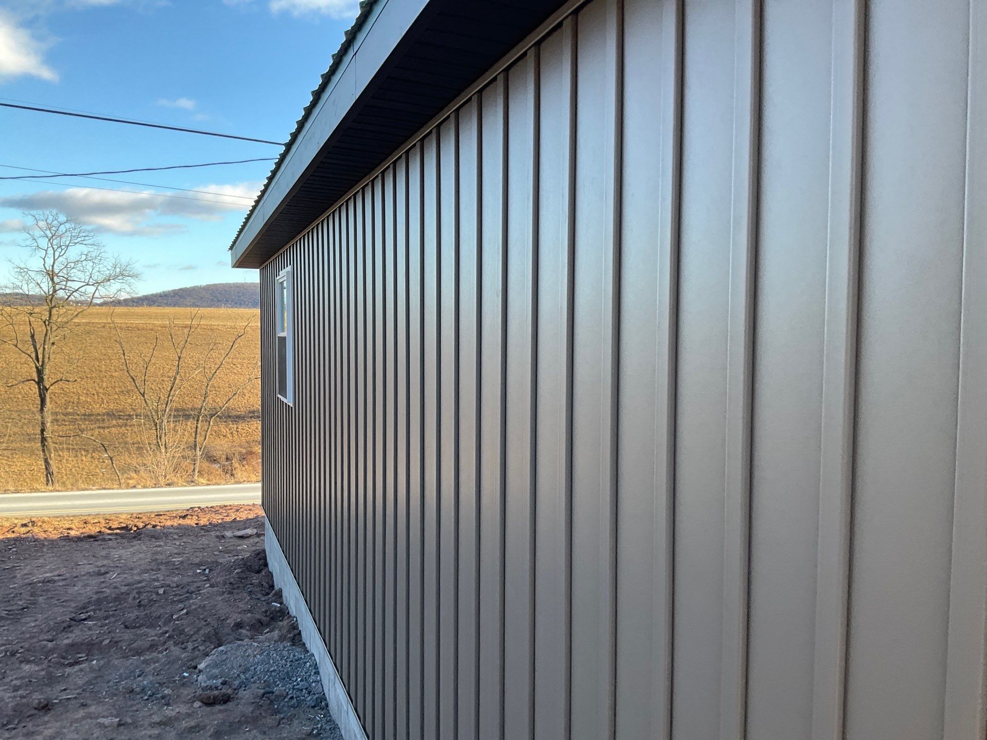 Multi-Story Residential Addition Featuring Textured Metal Siding in Millersburg by Esh Builders