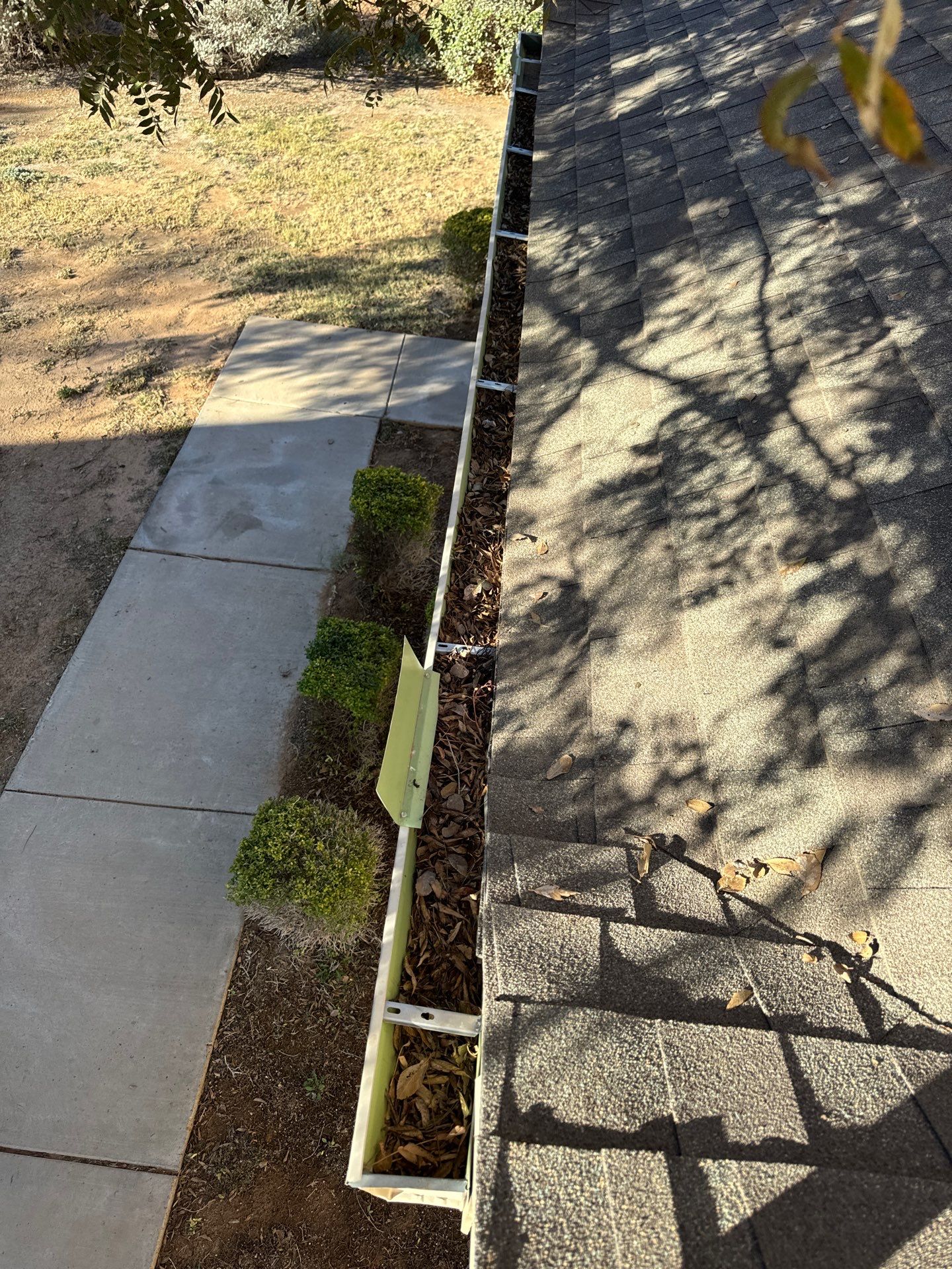 Commercial gutter cleaning Las Cruces, NM before photo with filled gutters