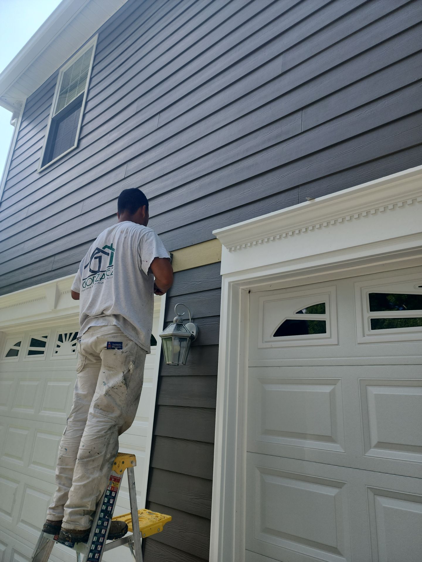 Siding replacement, exterior painting, and front door staining. by GonzalezPainters & Contractors Inc