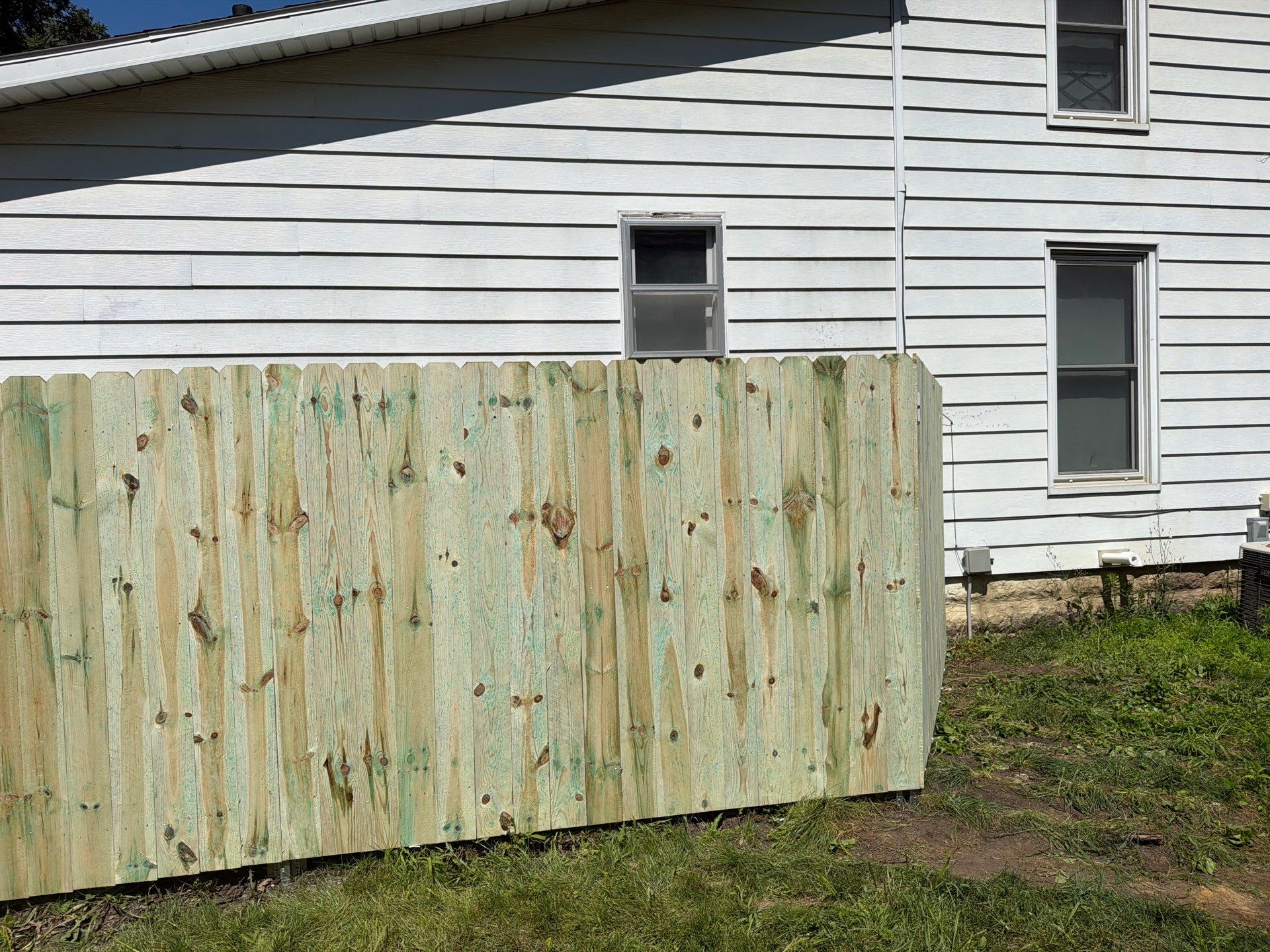 Pressure-Treated Wood Privacy Fence Installation in Waterloo by Perfect Picket Fence and Stain