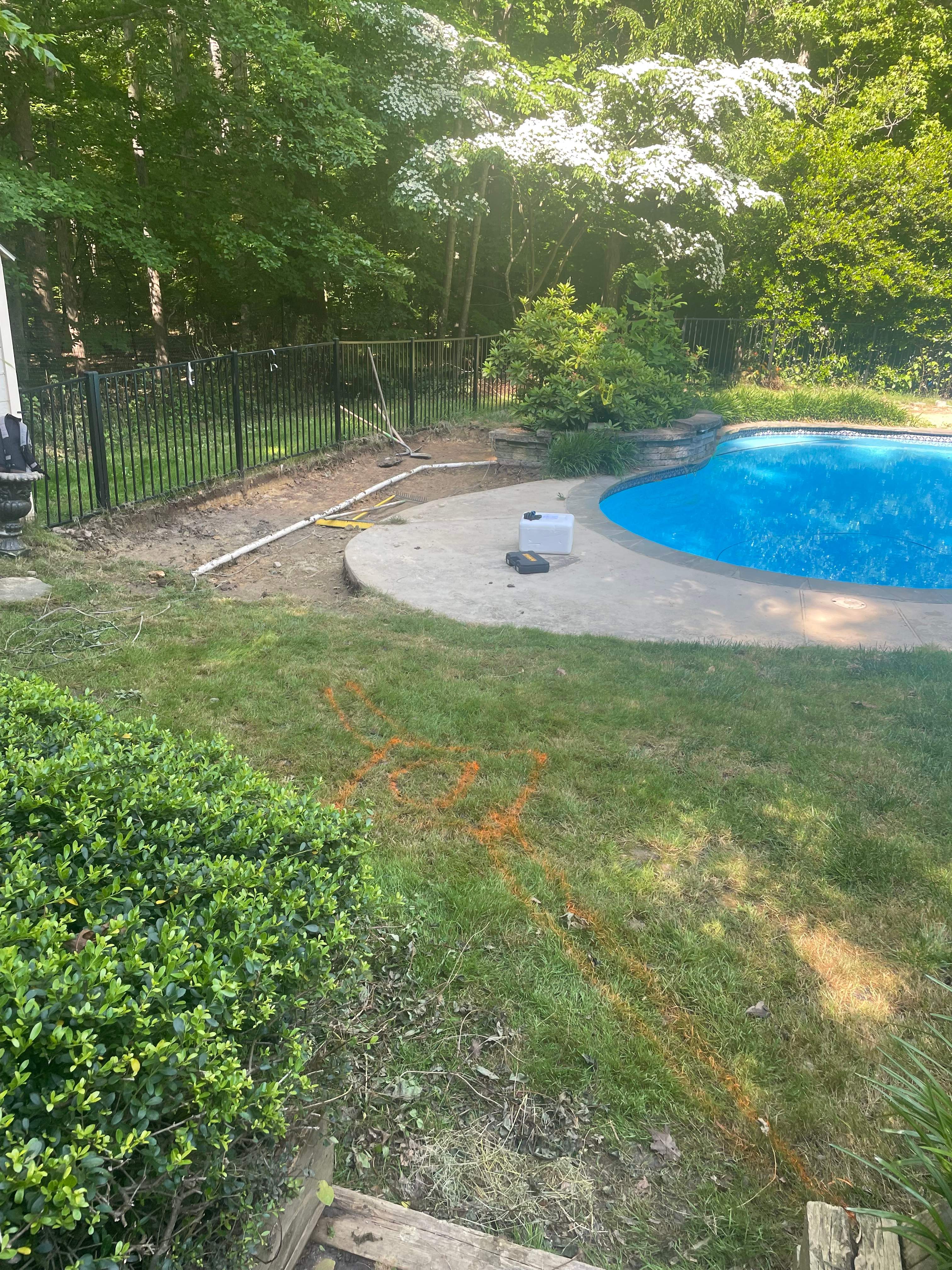 Pool Surround remodel with retaining walls, new waterfall and water slide by Fairfax Contractors, LLC