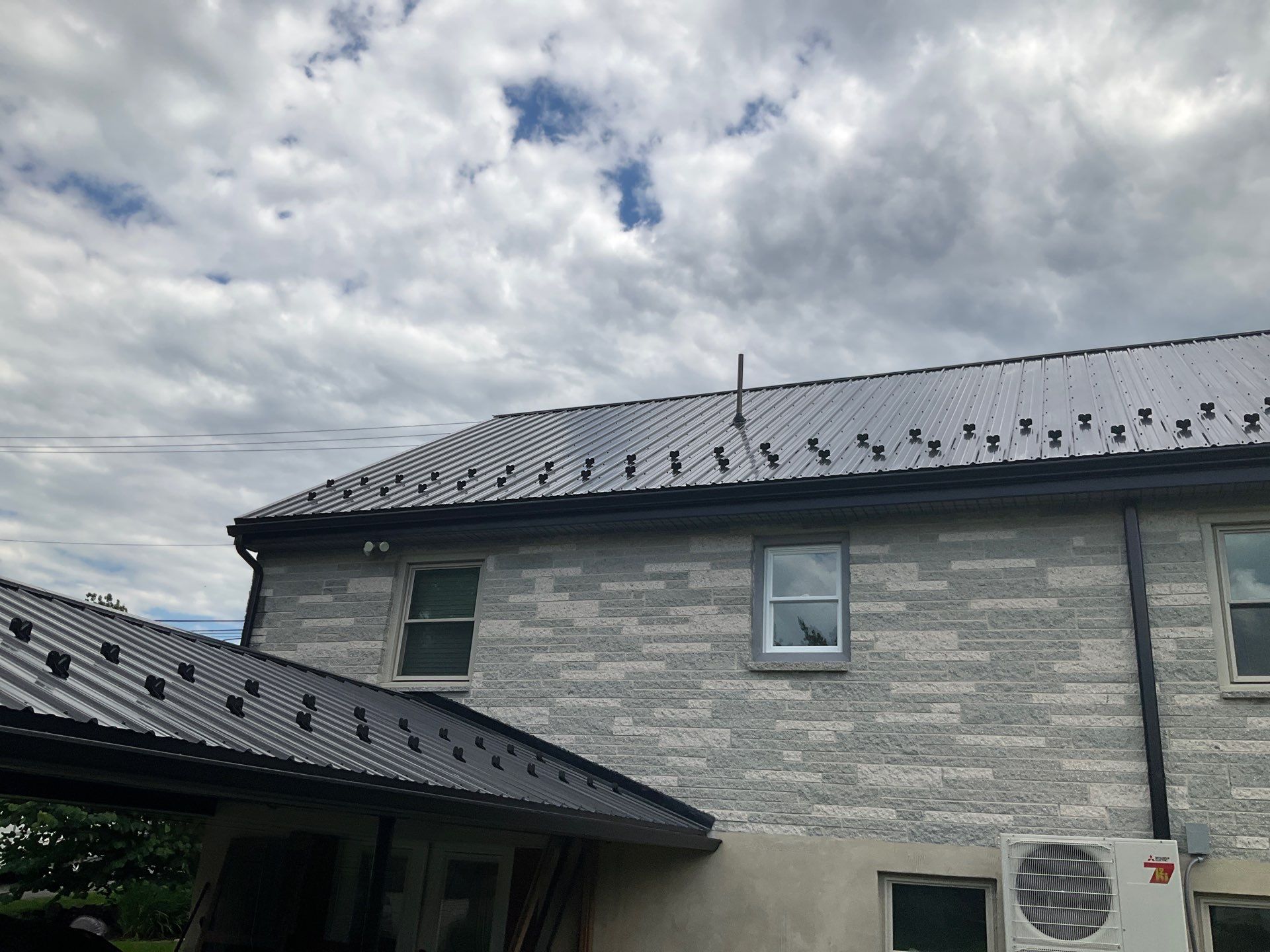 Metal Roofing, Board & Batten Siding, and Entry Door Transformation by Esh Builders