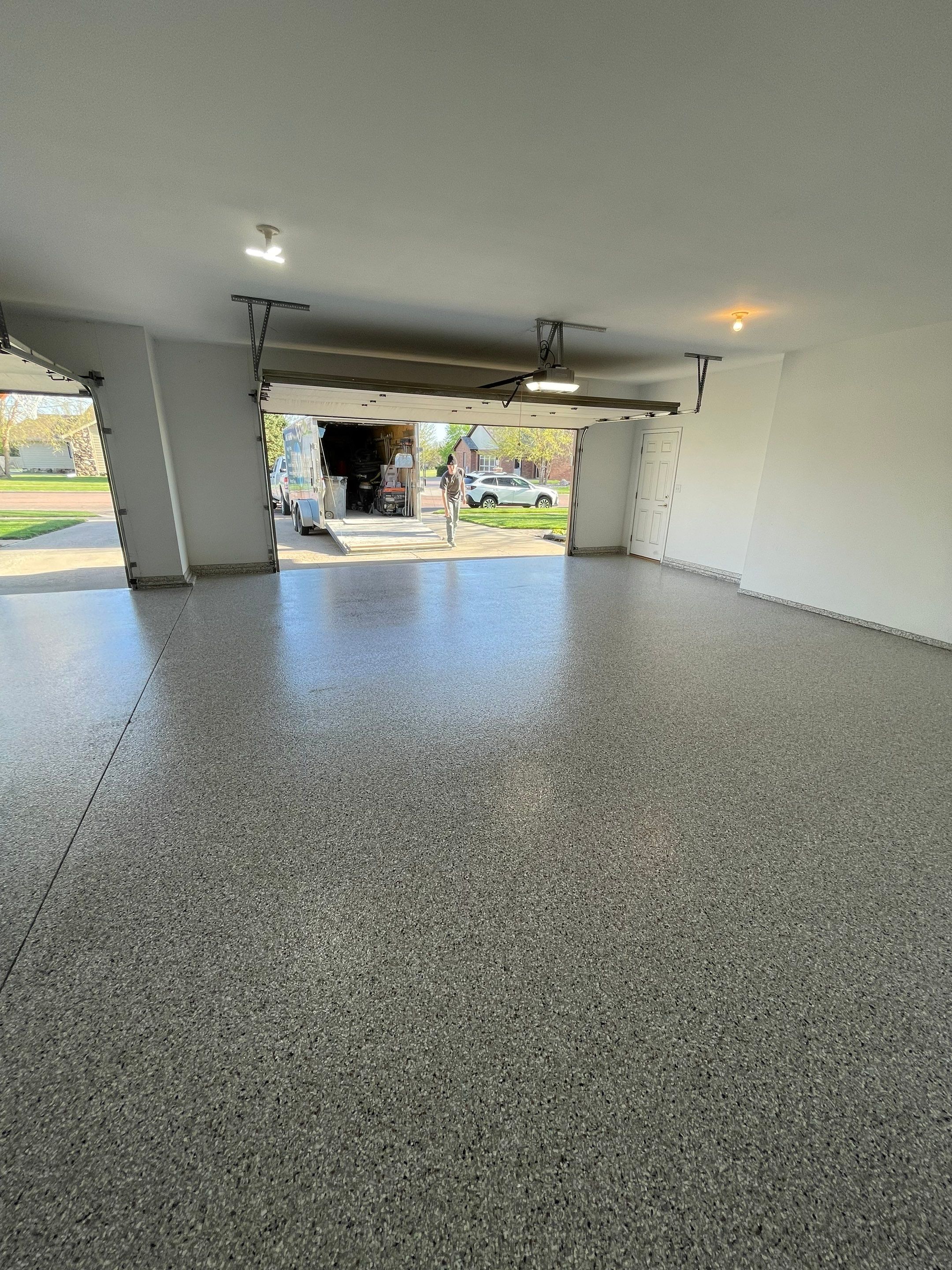 Yankton Garage Floor Restoration with Gray Speckled Epoxy Coating by Select Painting, Coatings & Garage Cabinets
